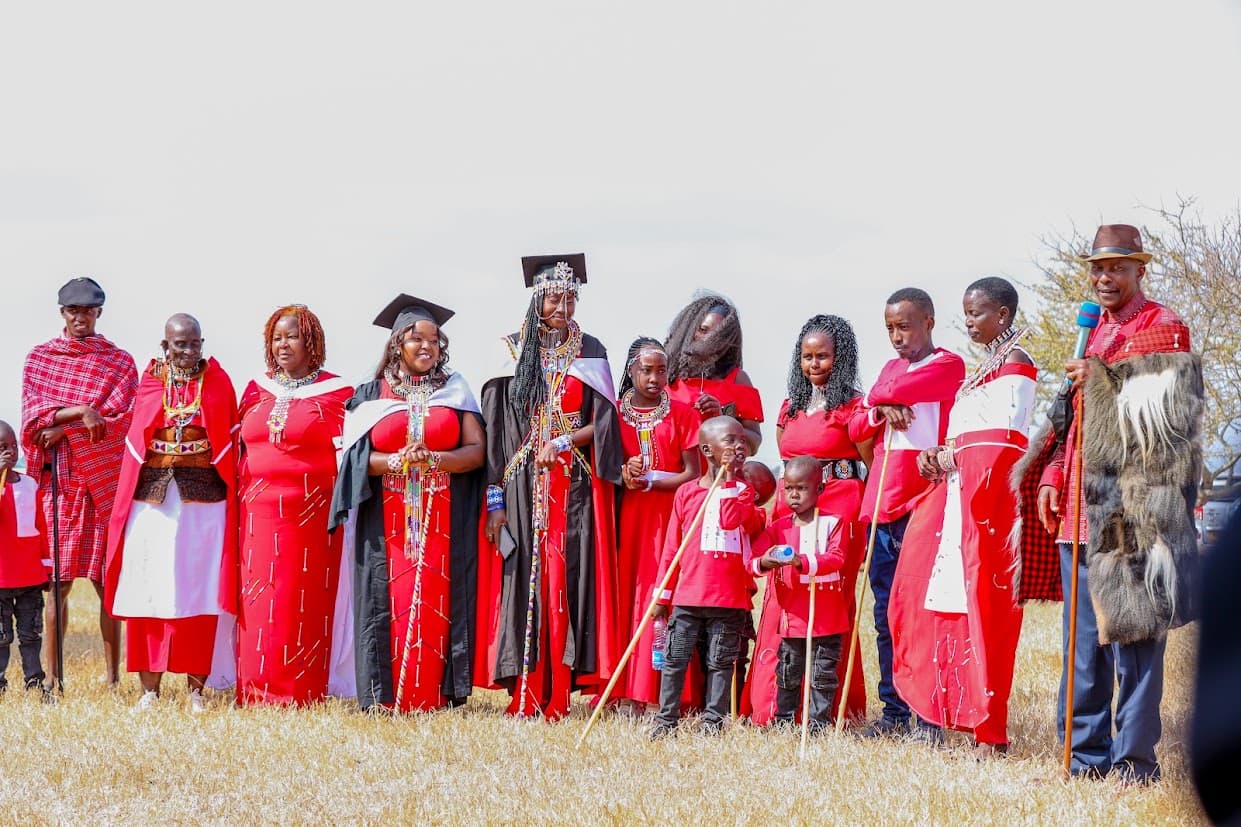 Community members and girls pictured together