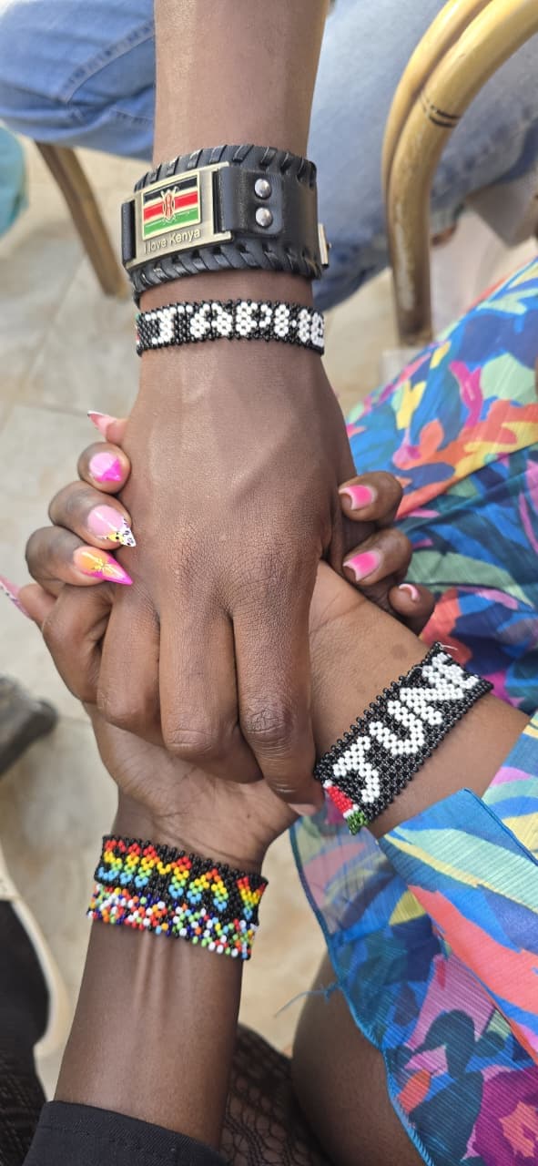 Hands supporting a young girl and her community